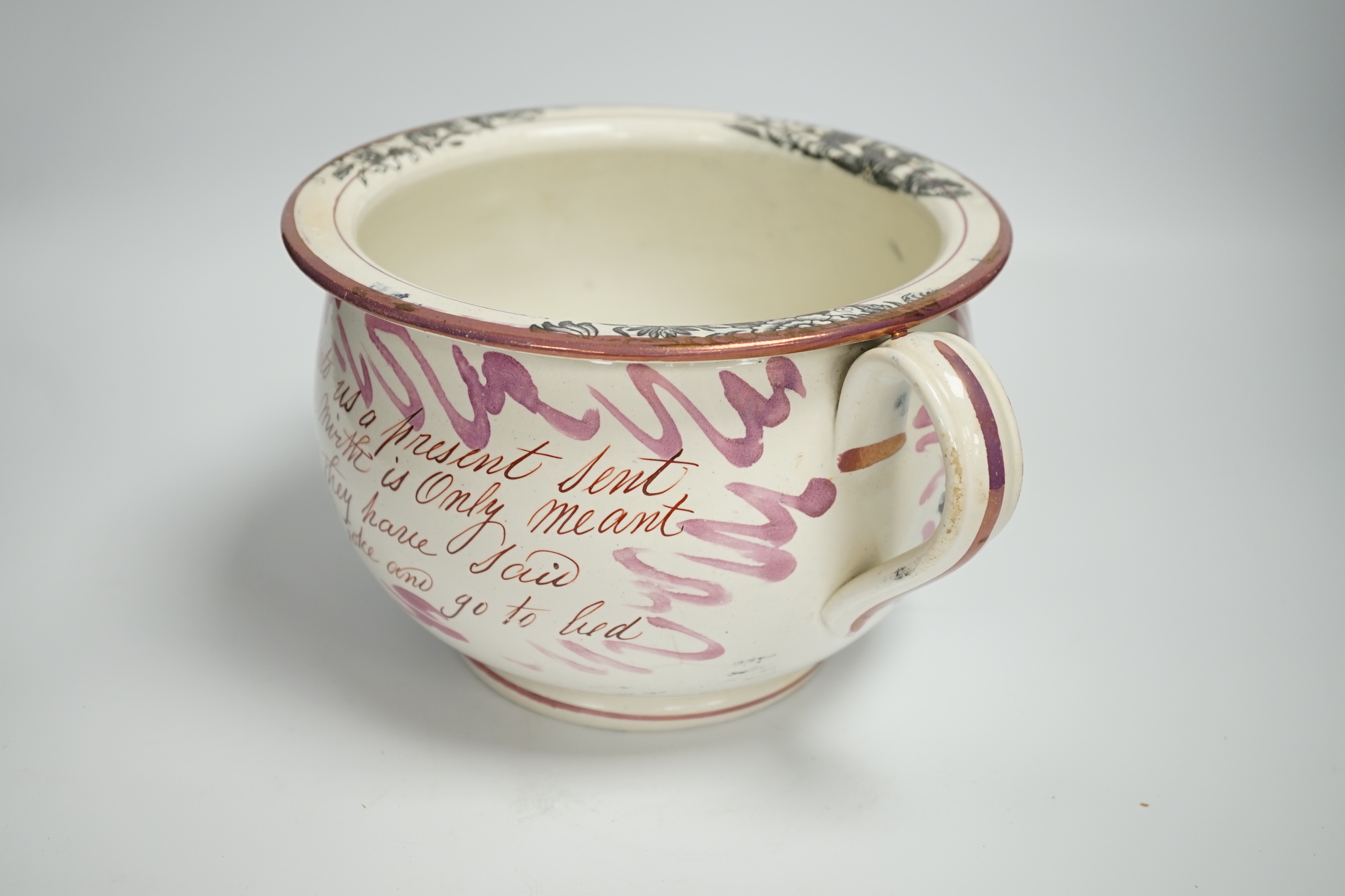 An early 19th century Sunderland or Tyneside pink lustre inscribed ’frog’ chamber pot, 14cm high